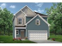 Charming two-story home with blue siding, gray accents, and a two-car garage at 60 Commons Cir, Clayton, NC 27520