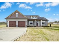 Charming single-story home featuring a two-car garage and a welcoming front porch at 618 Tart Town Rd, Dunn, NC 28334