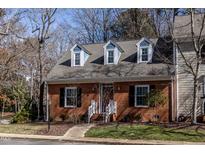 Charming brick home with dormer windows and beautifully landscaped front yard at 748 Weathergreen Dr, Raleigh, NC 27615
