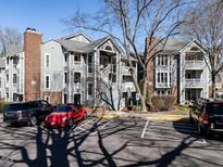 Multi-Gathering building with gray siding, brick accents, balconies, and parking area at 911 Washington St # 201, Raleigh, NC 27605
