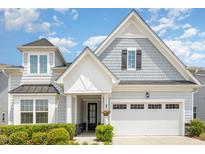 Charming home featuring a mix of gray shingle and lap siding and a black front door at 130 Ivory Ln, Raleigh, NC 27610