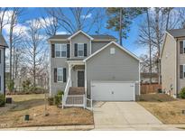 Charming two-story home with gray siding, black shutters, and attached two-car garage at 162 W Lumber Ct, Clayton, NC 27520