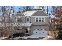 Charming two-story home featuring a covered front porch, neutral siding, and an attached two-car garage at 20 Argent Ct, Youngsville, NC 27596