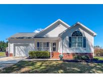 Charming single-story home with white siding, blue shutters, and a well-manicured front yard at 2105 Antioch Church Rd, Timberlake, NC 27583