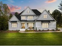 Stunning two-story home with a well-manicured lawn and a beautiful front porch at 2325 Ballywater Lea Way, Wake Forest, NC 27587