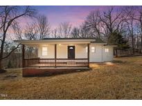 Charming single-story home with a cozy front porch and natural light at 2810 Hickory Hill Rd, Burlington, NC 27215