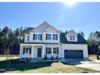 Charming two-story home with gray siding, black shutters, and attached two car garage at 377 Earnest Way, Kenly, NC 27542