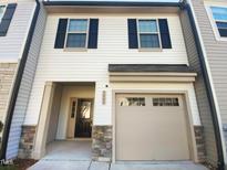 Charming townhome featuring a one car garage and stylish architectural details at 3804 Prince Noah, Wake Forest, NC 27587
