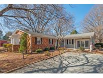 Charming home exterior featuring a combination of brick and siding with a well-maintained front yard at 6017 Charlana Dr, Durham, NC 27712