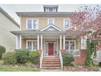 Charming two-story home with a inviting front porch and beautiful landscaping at 102 Westside Dr, Chapel Hill, NC 27516