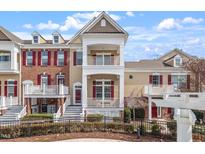Charming townhome with a double balcony and landscaped yard featuring a black metal fence at 10321 Sablewood Dr # 108, Raleigh, NC 27617