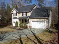 Charming two-story home with an attached garage and a well-maintained front lawn at 1226 Woodland Church Rd, Wake Forest, NC 27587