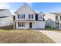 Charming two-story home with a covered front porch and attached garage at 1420 Springshire Ct, Raleigh, NC 27610