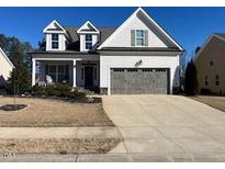 Charming two-story home featuring a symmetrical design and a well-maintained front yard at 145 Plantation Dr, Youngsville, NC 27596