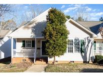 Charming home with a cozy front porch and well-maintained landscaping at 1614 W Cotton Gin Dr, Clayton, NC 27527