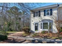 Charming townhome exterior featuring a well-manicured lawn and cozy front porch with tasteful decor at 174 St. Andrews Ln, Chapel Hill, NC 27517