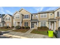 Charming townhouse with stone accents, neutral siding, and well-maintained front yard landscaping at 360 Red Elm Dr, Durham, NC 27713
