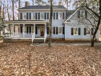 Charming two-story home featuring a welcoming front porch and classic design elements at 4016 Ridgebrook Bluffs Dr, Raleigh, NC 27603