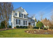 Charming two-story home with a manicured lawn, circular window, and black window shutters at 509 Loblolly Dr, Durham, NC 27712