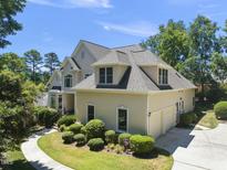 Two-story home boasts lush landscaping, attached two-car garage, and neutral stucco exterior at 51207 Eastchurch, Chapel Hill, NC 27517
