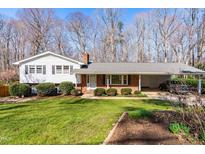 Charming split-level home with a brick facade, well-maintained lawn, and a convenient carport at 6500 Brandywine Rd, Raleigh, NC 27607