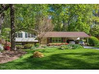 Charming home with a well-manicured front yard, lovely landscaping, and a convenient carport at 6504 Brandywine Rd, Raleigh, NC 27607