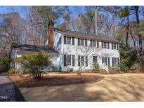 Traditional two-story home featuring black shutters and a brick chimney at 816 Churchill Dr, Chapel Hill, NC 27517