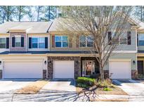 Attractive townhomes featuring stone accents and well-maintained landscaping in a quiet neighborhood at 107 Vickery Hill Ct, Durham, NC 27703