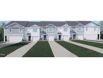 Charming townhomes featuring attached garages, white exteriors, and well-maintained lawns at 251 Perseus St, Angier, NC 27501