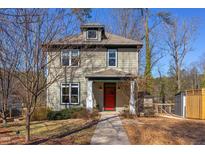 Charming two-story home featuring a red front door, complemented by well-maintained landscaping and mature trees at 2831 Herring Blvd, Durham, NC 27704