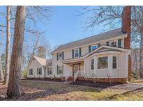 Traditional two-story home with green shutters, brick chimney, and front porch at 3023 Whitfield Rd, Chapel Hill, NC 27514