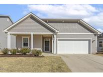Charming single-story home with gray siding, white trim, a manicured lawn, and an attached two-car garage at 3333 Sandy Meadows Dr, Fuquay Varina, NC 27526