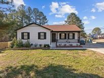 Charming single-story home with black trim, a covered porch, and a well-maintained front lawn at 47 Angela Way, Durham, NC 27703