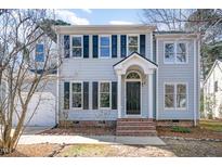 Charming two-story home with blue siding, black shutters, and a welcoming front entrance at 5 Bridgeport Dr, Durham, NC 27713