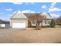 Charming single Gathering home with a manicured lawn, two-car garage and attractive landscaping at 61 Merlot Court Ct, Clayton, NC 27520