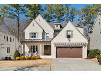 Charming two-story home featuring a brick exterior, covered porch, and a well-manicured front yard at 8013 Ghost Pony Trl, Raleigh, NC 27613