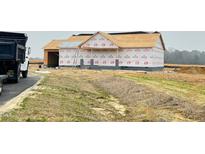 New home under construction with ladder, visible house wrap, and brown roof underlayment at 82 Asher Pointe Way, Benson, NC 27504