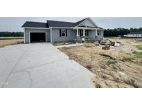 Charming gray home with a black roof, a driveway, and under-construction landscaping at 82 Asher Pointe Way, Benson, NC 27504