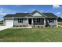 Charming single-story home featuring gray siding, stone accents, and an attached garage at 82 Asher Pointe Way, Benson, NC 27504