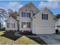 Charming two-story home featuring an attached two-car garage and manicured front lawn at 106 Trumbell Cir, Morrisville, NC 27560