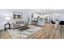 Inviting living room featuring stylish decor, modern furniture, and an open layout flowing into the kitchen and dining area at 1253 Russet Ln, Apex, NC 27523
