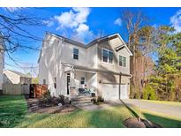 Charming two-story home featuring stone accents, a two-car garage, and a well-manicured lawn at 13 Piccadilly Ct, Durham, NC 27713
