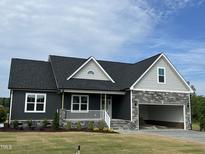 Charming new construction home featuring stone accents and a welcoming front porch at 143 Prency Ln, Middlesex, NC 27557