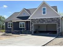 Two-story home featuring a stone-accented facade and attached two-car garage at 143 Prency Ln, Middlesex, NC 27557