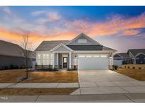 Charming single Gathering home with beautiful curb appeal, manicured lawn and two car garage at 1727 Pinecliff Ct, Fuquay Varina, NC 27526