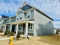 Charming two-story home with gray siding, white trim, and well-maintained landscaping at 1981 Rosedale Ridge Ave, Wake Forest, NC 27587