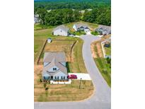 Beautiful aerial view of a two-story home with a large, fenced-in backyard and neighborhood street at 23 Tullamore Ln, Four Oaks, NC 27524