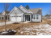 Charming single-story home with a well-maintained lawn and attached two-car garage at 2321 Calluna Ct, Fuquay Varina, NC 27526