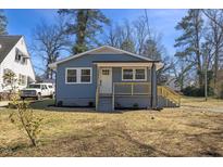 Charming blue home with a quaint front porch and well-maintained landscaping at 2611 Atlantic St, Durham, NC 27707