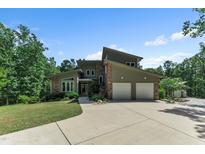 Stunning contemporary home featuring a two-car garage, stone accents, and professional landscaping at 295 Cedar Rock Trl, Fuquay Varina, NC 27526